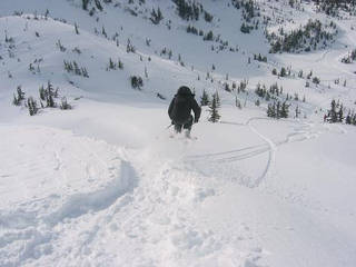 Skier Adam Crocker jumps for joy over Alaskan snow.