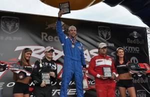 Snowboarder Nick Baumgartner atop the TORC Series podium at Crandon, Wisc.