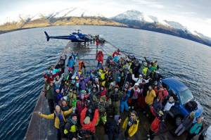 World Heli Challenge competitors cross New Zealand's Lake Wanaka on a barge Monday to access the competition site on Mt. Albert. (photo: Tony Harrington)