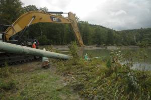 Sugarbush employees work Tuesday morning to repair snowmaking pond damage from runoff spurred by rainfall from Tropical Storm Irene. (photo: Sugarbush Resort)