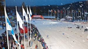 Athletes ski through the stadium in the darkness at the Ruka Triple in Kuusamo, Finland on Sunday. (photo: Ruka/Teemu Lahtinen)