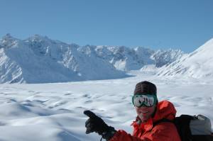 Olympian and World Cup ski racer Tommy Moe points out the amazing terrain of Alaska's Tordrillo Mountains.