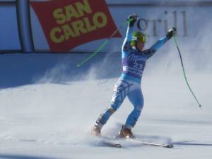 Stacey Cook, of Mammoth Lakes, Calif., raises her hands in excitement after finishing sixth in the Cortina downhill on Saturday. (photo: Doug Haney/U.S. Ski Team)