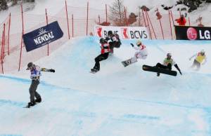 The finals in men's snowboard cross Thursday in Veysonnaz, Switzerland. Andrey Boldykov (RUS) in blue, Nate Holland (USA) in red, Pierre Vaultier (FRA) in green, Mateusz Ligocki (POL) in white, Tony Ramoin (FRA) in black, Anton Lindfors (FIN) in yellow. (photo: FIS/Oliver Kraus)