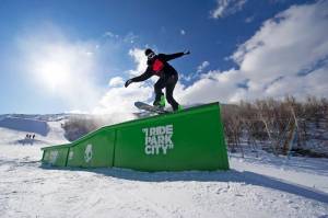 Snowboarder Blaze Kotsenburg enjoys some sunny laps through the terrain park at Park City. (photo: PCMR)