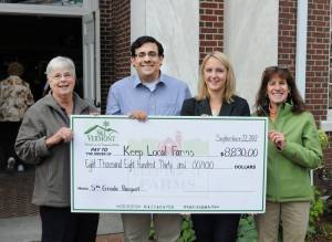 Sarah Neith from Ski Vermont presents an $8830 check to Keep Local Farms. Also pictured: Marion Seifert, a dairy farmer from Orwell, VT, Ryan Torres from the Vermont Community Foundation and Jolinda Laclair, Vermont's Deputy Secretary of Agriculture. (photo: Ski Vermont)