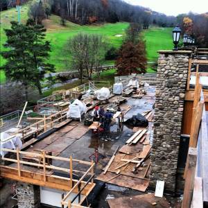 Workers in late October put the finishing touches on the stone work and firepit on the main level deck of the new Holiday Valley Lodge. (photo: Holiday Valley Resort)