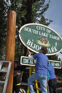 Employees of Heavenly and Kirkwood Mountain Resorts repaint the sign for Bijou Park in South Lake Tahoe, Calif. on Saturday. (photo: Vail Resorts)