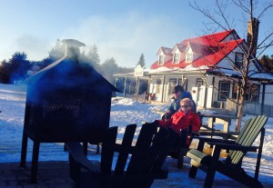 Skiers surround an outdoor fireplace at Ski de Fond. (photo: FTO/Alan Wechsler)