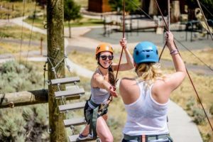 Ness Dziemian reaches out to help on the National Ability Center ropes course. (photo: Tyler Tate)