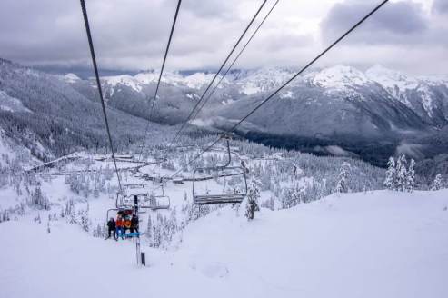 View of the chairlift and skiers, and snow-covered ski slopes and valley in Mount Baker in the Pacific North-west, USA – Weather to ski – Snow report, 22 November 2024