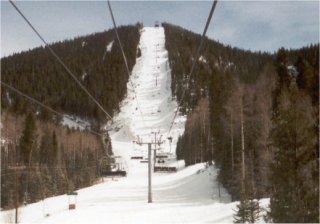 Silver Chute and Maxwell's Grant, two of Angel Fire's steepest runs, are visible to climber's left of the Chile Express chair (photo Jim Bell)